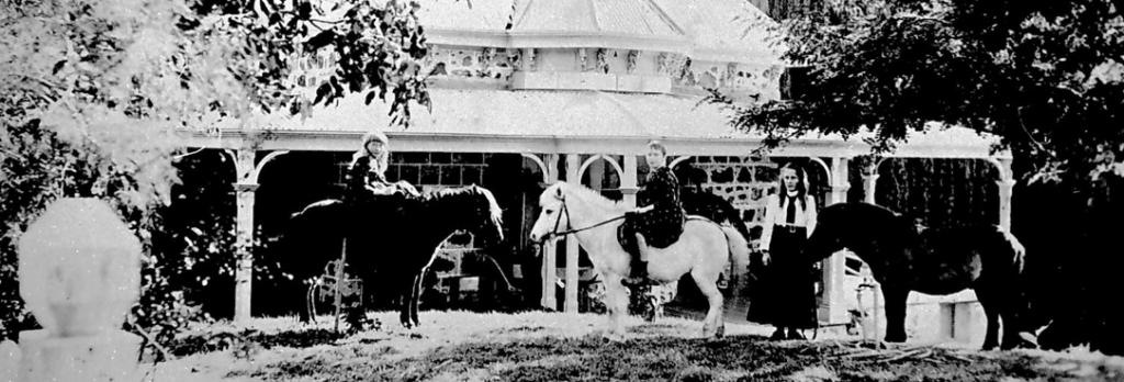 nineteenth century homestead with ponies black and white image.